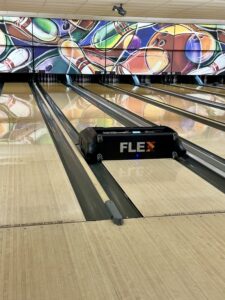 Lane Conditioning Machine – Professional Oil Patterns for League Bowlers A lane conditioning machine applying oil to a bowling lane, ensuring optimal lane conditions for league and competitive bowlers