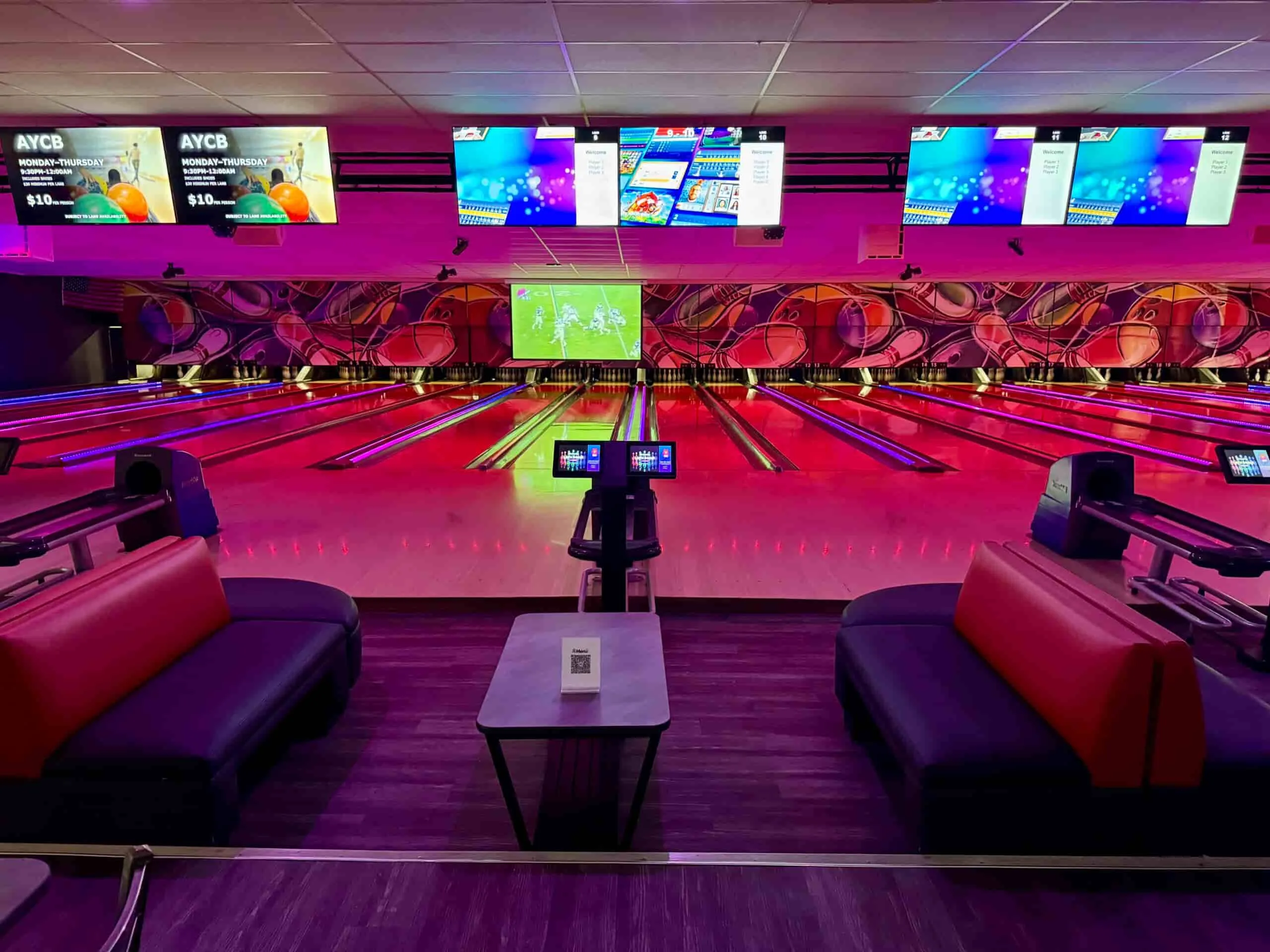 VIP bowling lanes at Strikers Sunrise featuring comfortable lounge seating, interactive scoring screens, neon lighting, and modern bowling lanes in Sunrise, Florida.